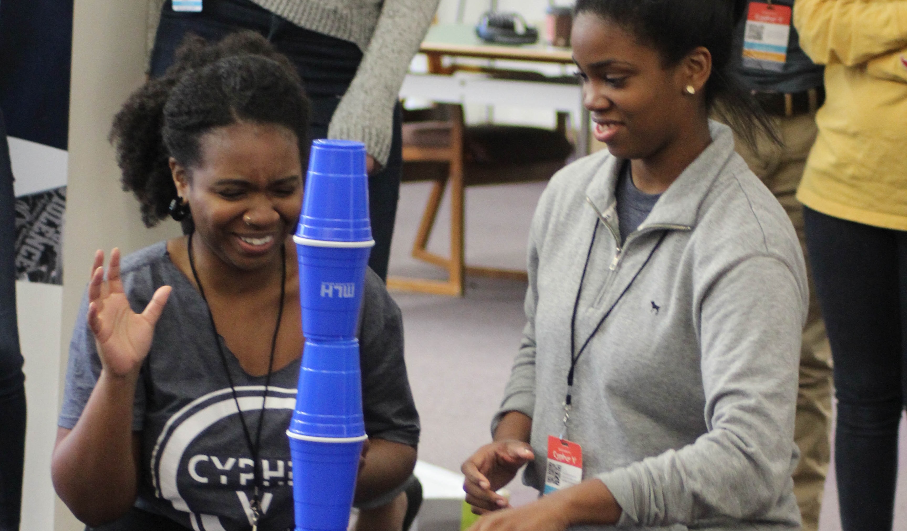 Two people stacking cups at Cypher